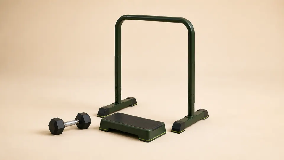 A low calf-raise block with one dumbbell and a stable support rail nearby.